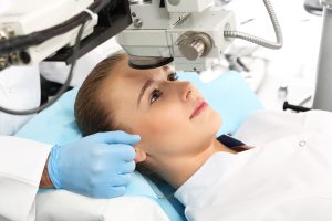 patient laying down while an eye exam and operation is planned